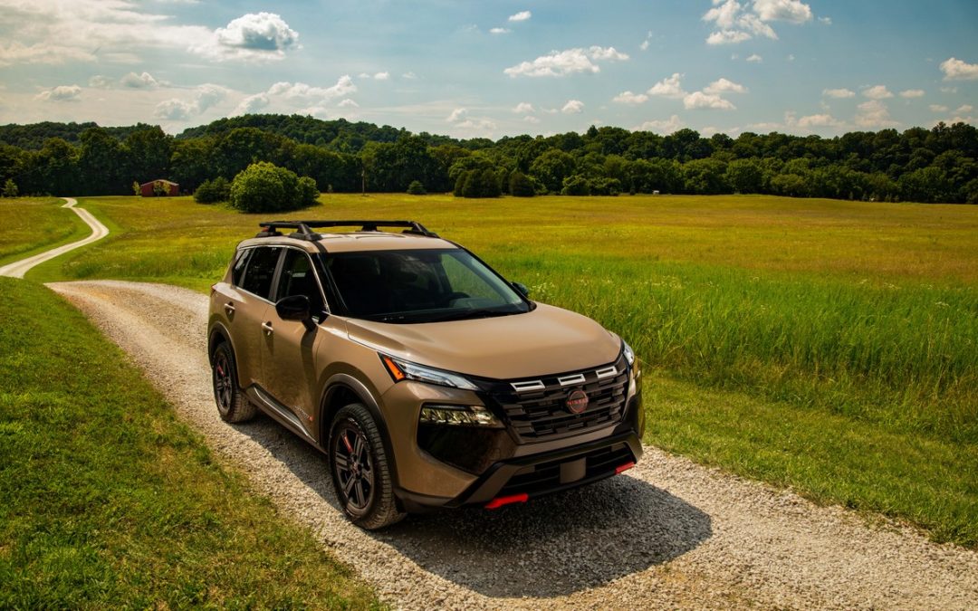 Nissan Rogue Rock Creek driving on a gravel road near open Tennessee-style fields