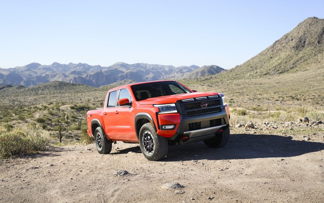 Red Nissan Frontier PRO-4X pickup truck on rugged terrain for Nissan truck service near Cookeville, TN